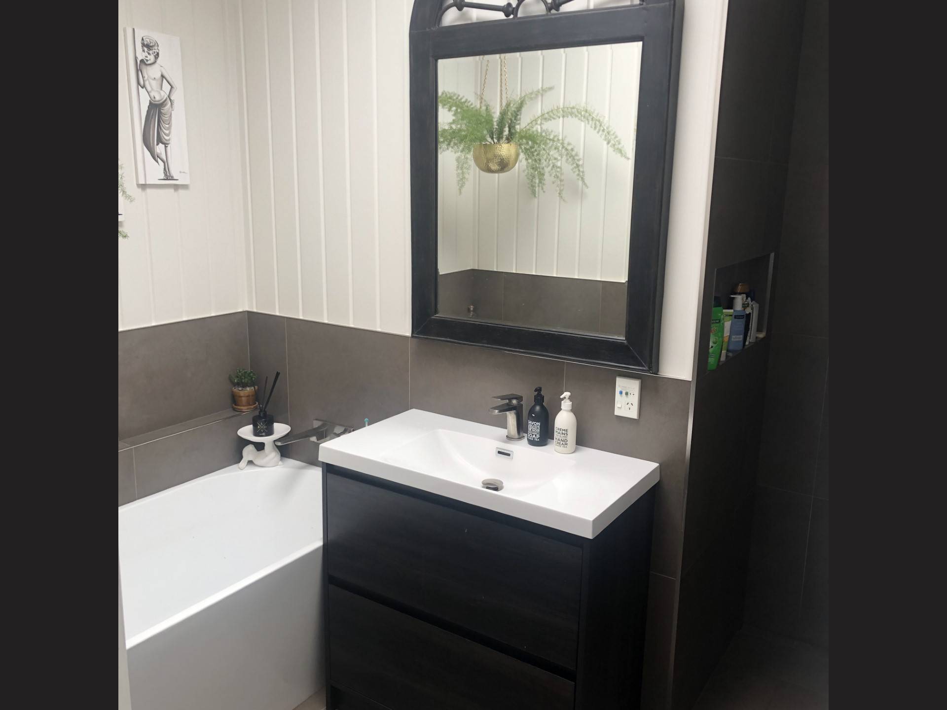 Renovated bathroom with vanity and small bath