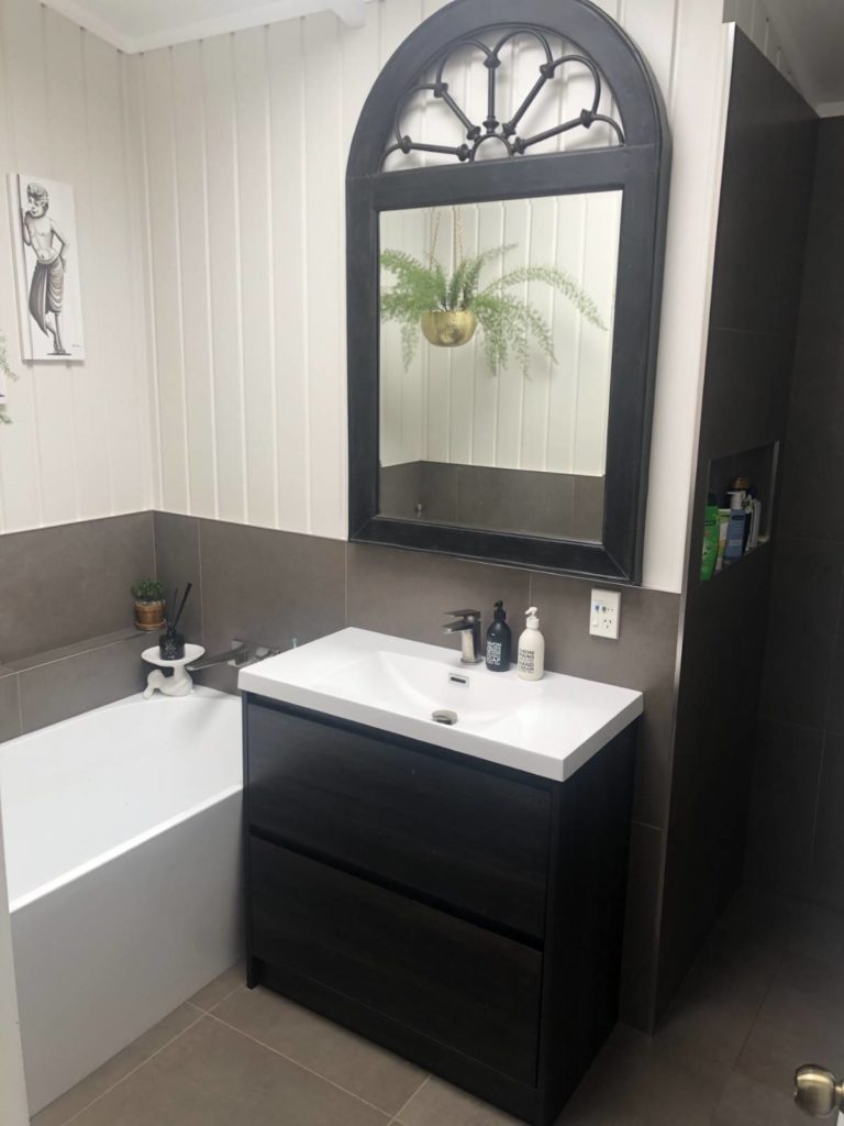 Renovated bathroom showing bath and vanity