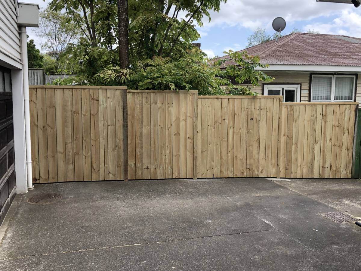 New wooden fence along driveway